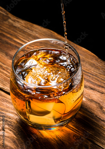 whiskey with ice on a wooden table
