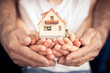 Family holding house in hands Family holding house in hands