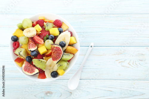 Fresh fruit salad on a white wooden table