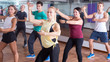 Happy beginner dancers studying zumba elements Happy beginner dancers studying zumba elements