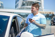 man with the phone near the car man with the phone near the car
