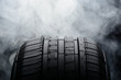 Car tire and smoke on black background Car tire and smoke on black background