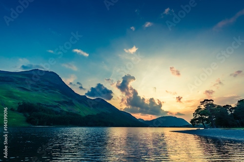 Stunning colorful dusk at lake in District Lake, England