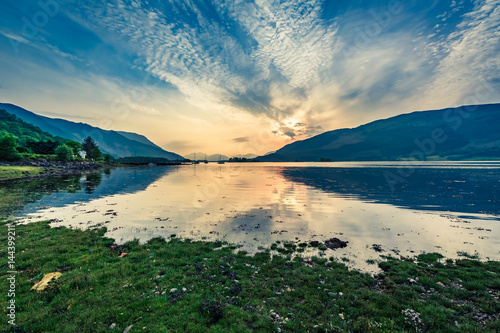 Beautiful sunset over the boats on lake, Scotland