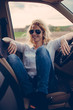 Female driver sitting in off road vehicle on road trip Female driver sitting in off road vehicle on road trip