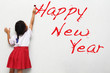 Girl writing happy new year Girl writing happy new year