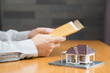 Businessman holding home loan application Businessman holding home loan application