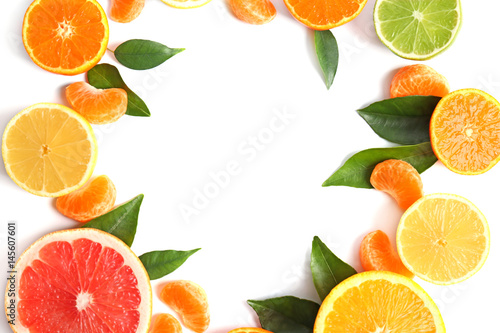Frame of juicy citrus fruits on white background