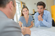 Young couple in meeting with property developer Young couple in meeting with property developer