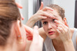 beautiful girl applying or removing a contact lens with mirror beautiful girl applying or removing a contact lens with mirror