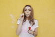 Attractive cute teenage girl against the background of yellow wall. Young pretty girl posing in the street. Sunrise time, happy face woman, cute, attractive, fashion model, hipster style. Attractive cute teenage girl against the background of yellow wall. Young pretty girl posing in the street. Sunrise time, happy face woman, cute, attractive, fashion model, hipster style.
