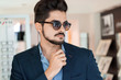 Handsome fashion young man posing in new sunglasses Handsome fashion young man posing in new sunglasses