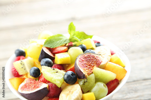 Fresh fruit salad on a grey wooden table