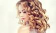 Beautiful blonde model girl with curly hair .Young woman with short wavy hairstyle Beautiful blonde model girl with curly hair .Young woman with short wavy hairstyle