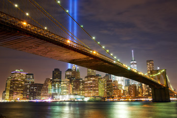 Brooklyn Bridge and Manhattan skyline with light beams