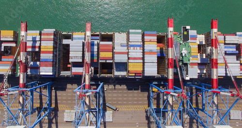 Plakat Port handlowy ze statkiem kontenerowym podczas załadunku i rozładunku - widok z góry na dół.