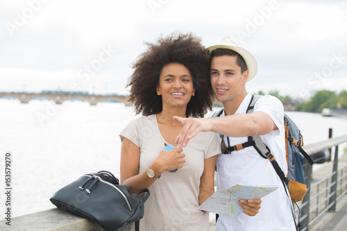 beautiful young couple against river in bordeaux