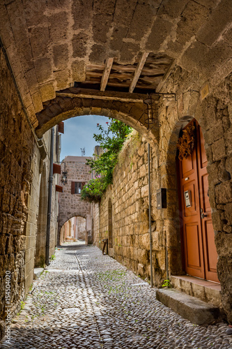 Fototapeta Charming narrow street in the old town of Rhodes, Rhodes island, Greece