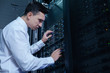 Nice male engineer checking the network server Nice male engineer checking the network server