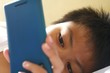 Young kid watching on a smartphone Young kid watching on a smartphone