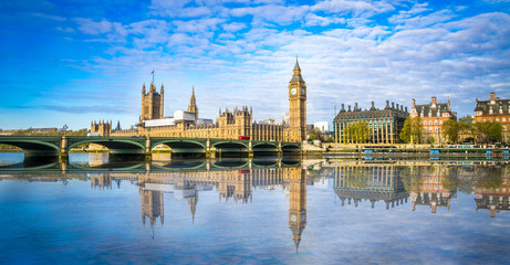Big Ben and Westminster parliament with blurry refletion in London, United Kingdom at sunny day.