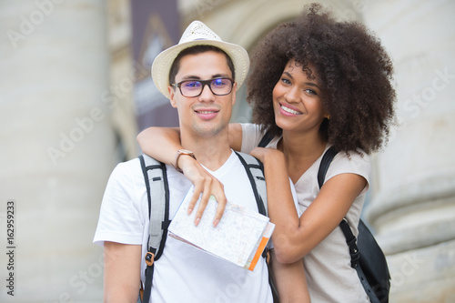happy tourists with map sightseeing city