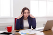 Frustrated business woman with headache at office Frustrated business woman with headache at office