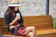Cheerful woman in the street drinking morning coffee in sunshine light Cheerful woman in the street drinking morning coffee in sunshine light