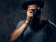 A man holds compact photo camera. A man holds compact photo camera.
