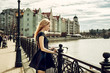 Beautiful young woman wearing fashion black dress walking in the street Beautiful young woman wearing fashion black dress walking in the street