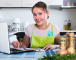 Woman making shopping list at kitchen. Woman making shopping list at kitchen.