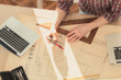 Architect with lap-tops, plans in a room lit by natural sunlight. Architect with lap-tops, plans in a room lit by natural sunlight.