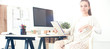 Young woman working in office, sitting at desk Young woman working in office, sitting at desk
