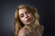 Attractive blonde woman on dark background . Attractive blonde woman on dark background .