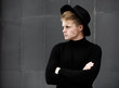 Young stylish man in trendy wear is looking away while standing outdoors. Street style. Young stylish man in trendy wear is looking away while standing outdoors. Street style.