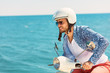 Handsome man posing on a scooter in a vacation context. Street fashion and style. Handsome man posing on a scooter in a vacation context. Street fashion and style.