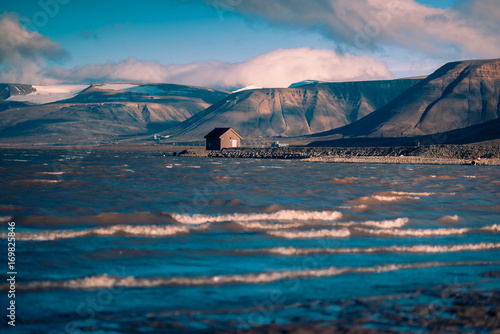 Landscape of a nature of a pink sunset with clouds in the mountains of Spitsbergen Svalbard near the Norwegian city Longyearbyen