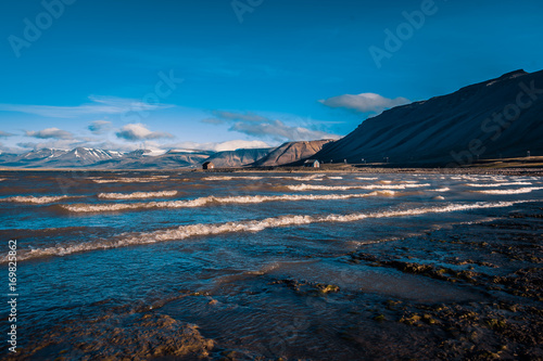 Landscape of a nature of a pink sunset with clouds in the mountains of Spitsbergen Svalbard near the Norwegian city Longyearbyen