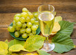 Wine grapes, grape juice. Аutumn leaves. a wooden table. Wine grapes, grape juice. Аutumn leaves. a wooden table.