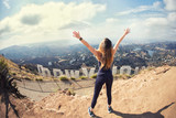 Young woman at the top of Hollywood, Los Angeles, California