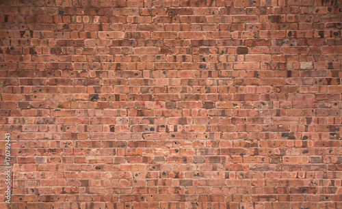 Weathered Red Brick Wall with Shadows