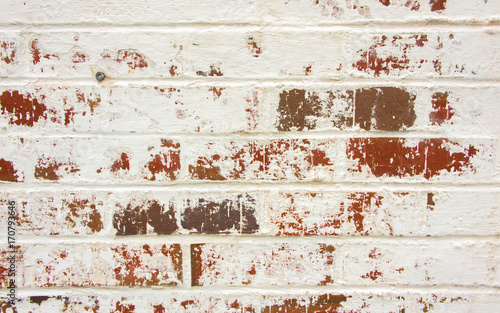 Red and Brown Brick Wall with Peeling White Paint