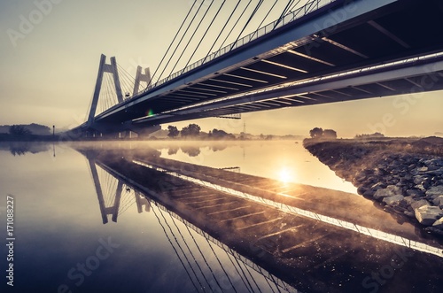 Obraz na płótnie Cable stayed bridge, Krakow, Poland, in the morning fog over Vistula river