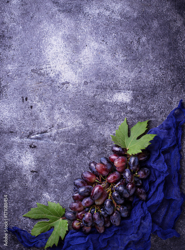 Bunch of purple grapes on concrete background
