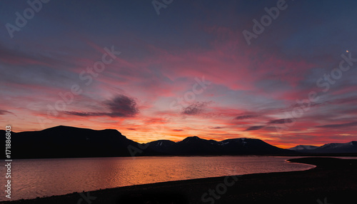 Landscape travel of a nature of a sunset sunrise with clouds in the mountains of Spitsbergen Svalbard near the Norwegian city Longyearbyen