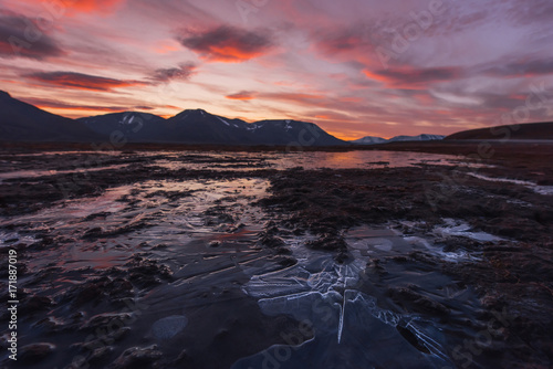 Landscape travel of a nature of a sunset sunrise with clouds in the mountains of Spitsbergen Svalbard near the Norwegian city Longyearbyen