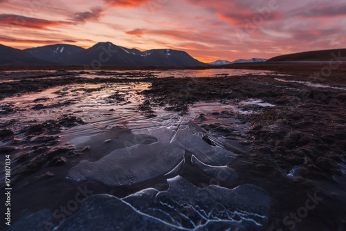 Landscape travel of a nature of a sunset sunrise with clouds in the mountains of Spitsbergen Svalbard near the Norwegian city Longyearbyen