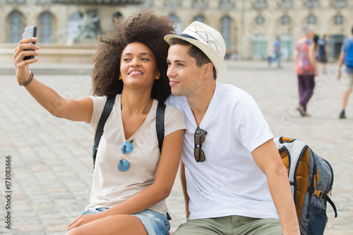 tourist couple taking selfies