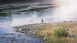fishing on the river. fisherman on a stony river. wide autumn river fishing on the river. fisherman on a stony river. wide autumn river