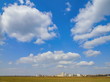 bright sky field town in the distance bright sky field town in the distance